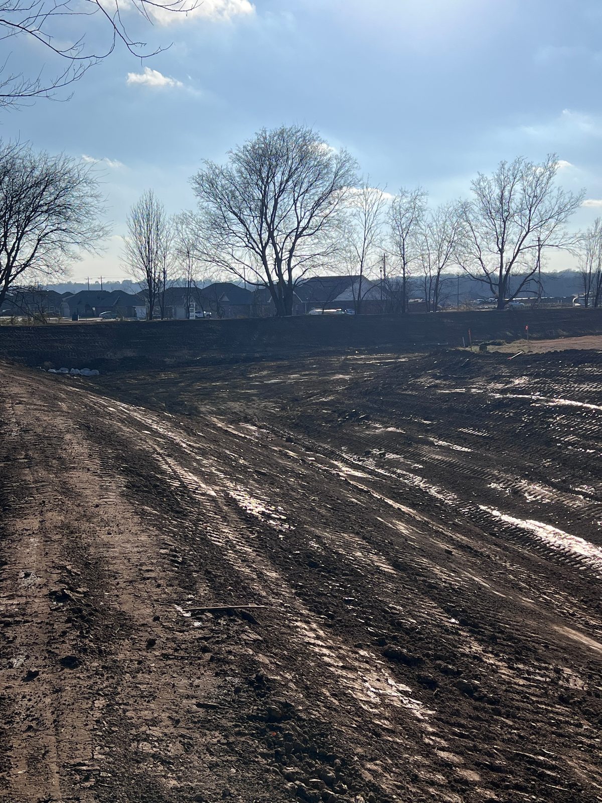 Cleared and graded acreage with a packed dirt access road